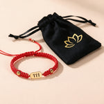 111 Angel Number Bracelet with the black lotus drawstring pouch it arrives in
