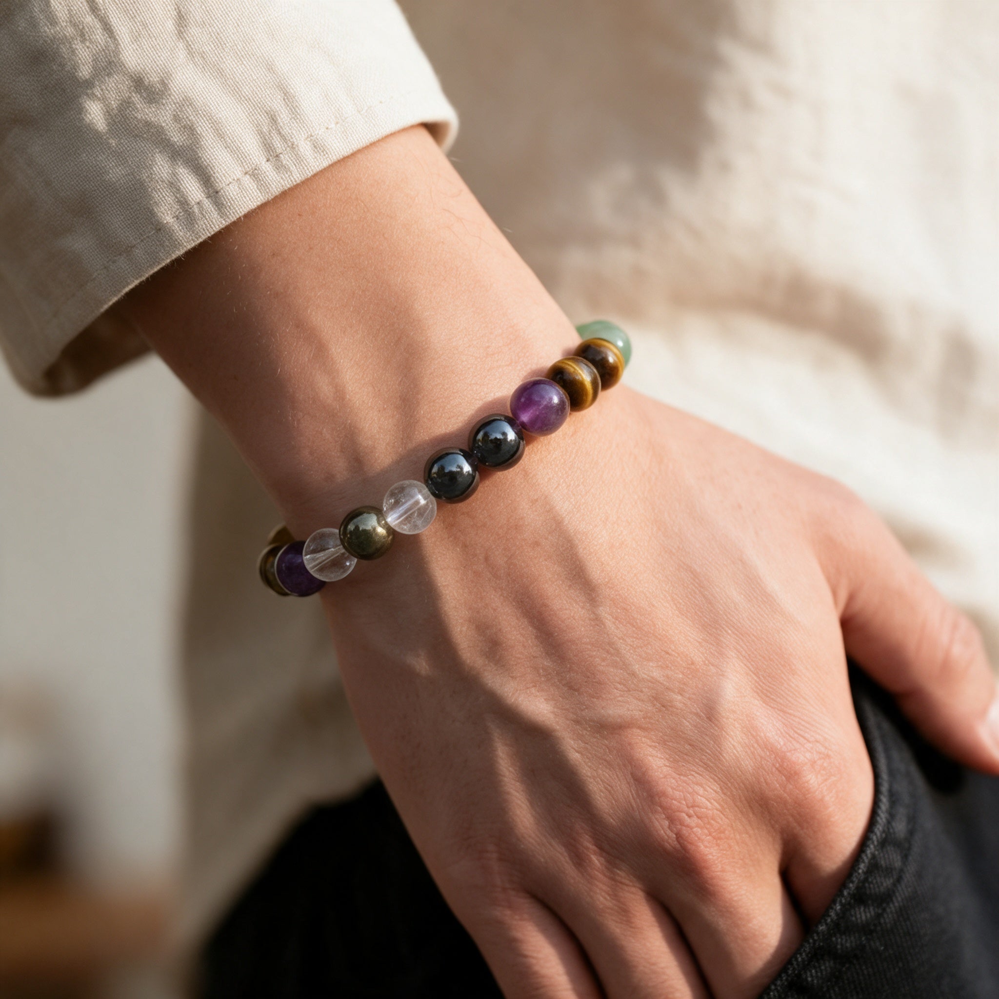 The Ultimate Abundance Bracelet worn on a wrist, eight millimetre stone beads on a stretch cord